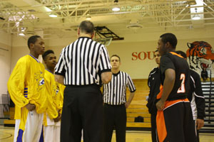 South men’s basketball captains Isaiah Wilson and Mahari Wilson participate in the coin toss prior to a recent game. against Edison. Coach Joe Hyser feels that a captian’s job is to be a leader and spokesperson for the team. 