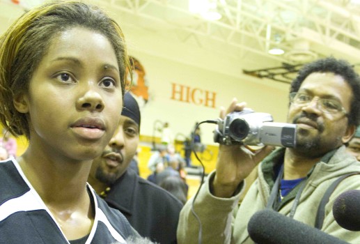 Tayler Hill is swamped by the press after a game during her senior year at South in 2009.