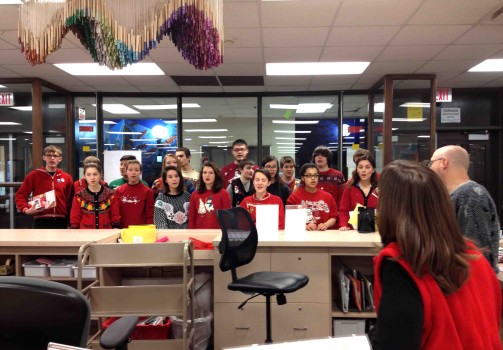 The pop singers in their Christmas sweaters serenade students and staff in the media center during second hour on the last day before break.  They sang Carol of the Bells, a frequently requested tune.  This was just one stop on their caroling tour of South