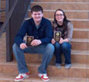 Junior Trace Thompson and senior Lillie Ouellette-Howitz display their plaques after winning the Minnesota High School Debate Tournament.