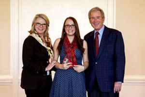 Senior Lillie Ouellette-Howitz with Laura and Geroge W. Bush, after winning the Annual High School Economic Debate Tournament.