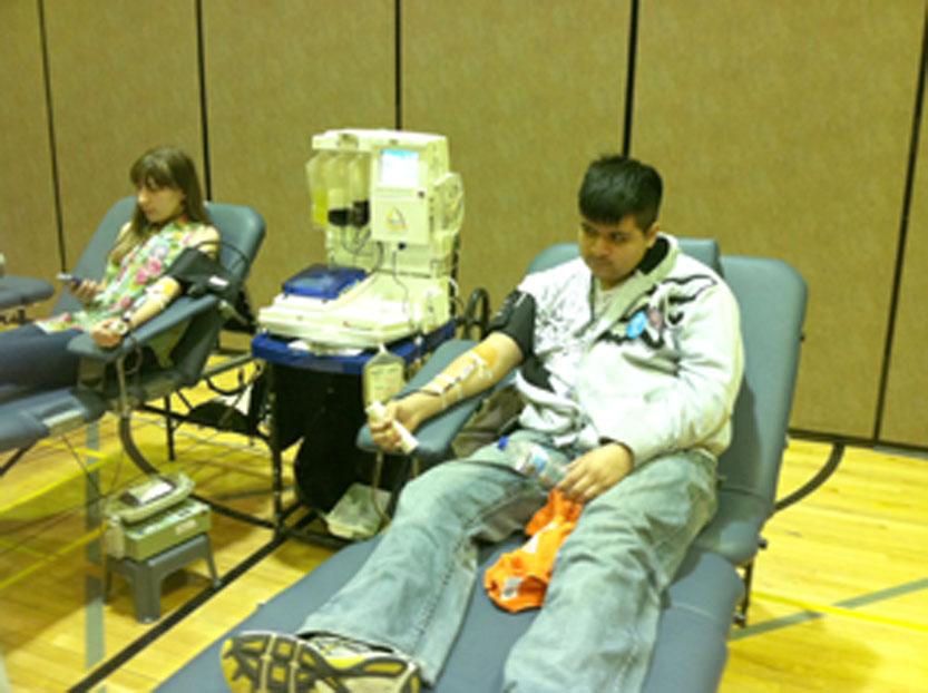 The South High Student Council organized a blood drive on Friday, April 18.  Throughout the day students went to the gym to donate.  After donating, students were invited to eat food in the gym to regain some strength.  In this photo, sophomore Kaitlyn White and junior Joesimar Montes donate blood during sixth hour.