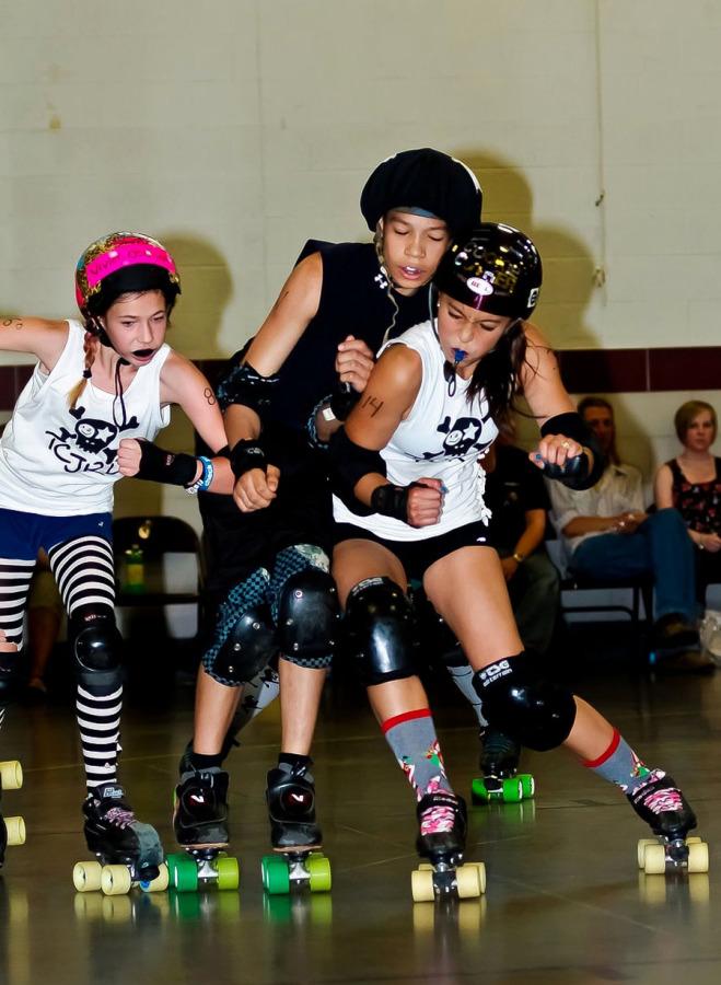 Junior Lily Eusebio participated in a junior roller derby league from 2010 to 2012. Pictured she checks an opponent during a bout. 
