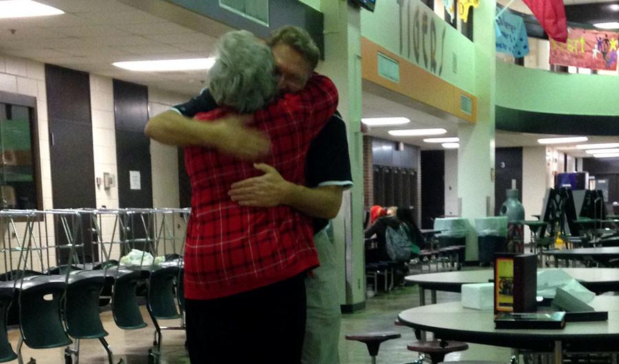 Mark Sanders hugs Mary Jonhigan, a South sports ticket seller, at a goodbye reception held at him for South.
