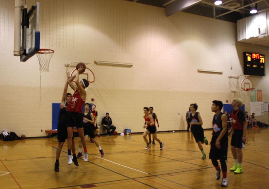 Senior Gunnar Rudrud attempts to dunk. His teammate, senior Jacob Patterson, described his favorite part of playing Park Board: [its] being able to play basketball again and being able to try things on the court that you wouldnt be able to in a competitive setting.