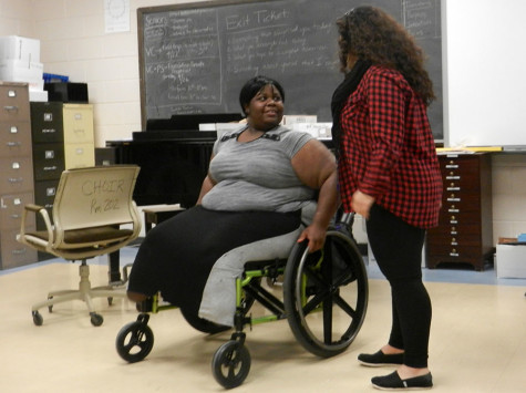 Senior Becky Moore is known for her outgoing personality. During a break in choir, Moore chats with a classmate. 