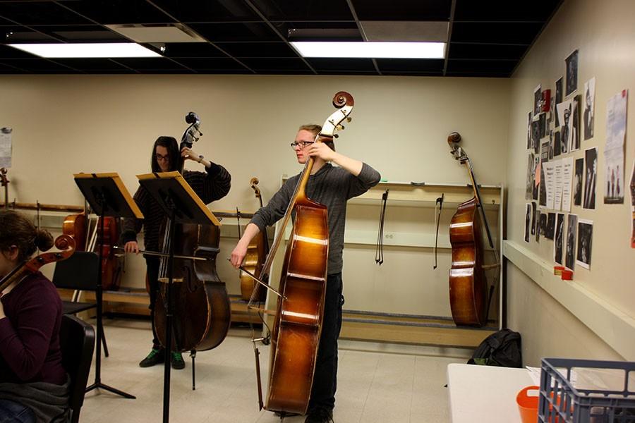 Bowing his cello gently Arthur Campbell, center practices in Orchestra. Campbell plans on being a composer in the future. “I feel like this year has been kind of like Ive stepped into the composing world” he explained. 