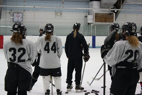 Head varsity girls hockey coach Sarma Özmen (middle) explains a drill to her team. Özmen is a player for the Latvian National Hockey Team and aspires to be a referee in the Olympics. “I think she raises the bar for us, but I think that’s a good thing, because it really helps us get better,” said sophomore Lilah Schulz.