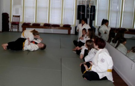 Two girls practice their Judo skills at Five Element Martial Arts at Cedar Avenue and East 38th street. The self-defense classes at FEMA focus on the “Five Fingers”: Mind, Voice, Escape, Fight, and Tell. The class emphasizes “knowing how to get out of those situations before they escalate,” sophomore Ingrid Zoll explained.