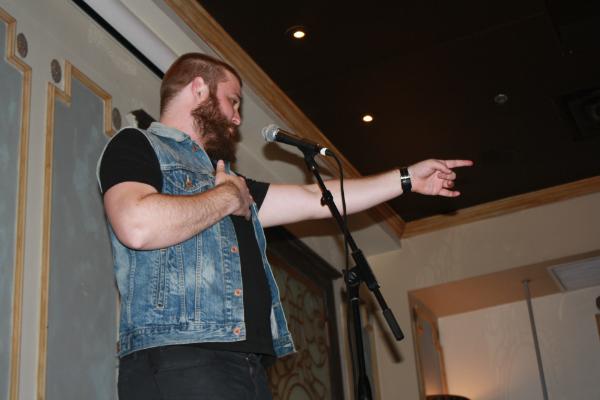 Neil Hilborn, a nationally renowned poet known for his spoken word piece "OCD", performs as a featured artist at the slam hosted at Kieran's Pub on March 22nd. Slams are a space for artists to perform poetry competitively.
