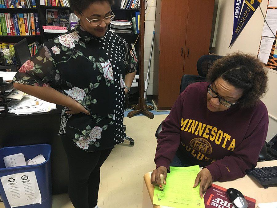 Senior Betty Mfalungundi gets a stamp from Nneka Abdullah, a CCC coordinator, to complete her senior check list. The checklist is one of the many things seniors need to complete in order to graduate. Photo: Paulina Poehlman