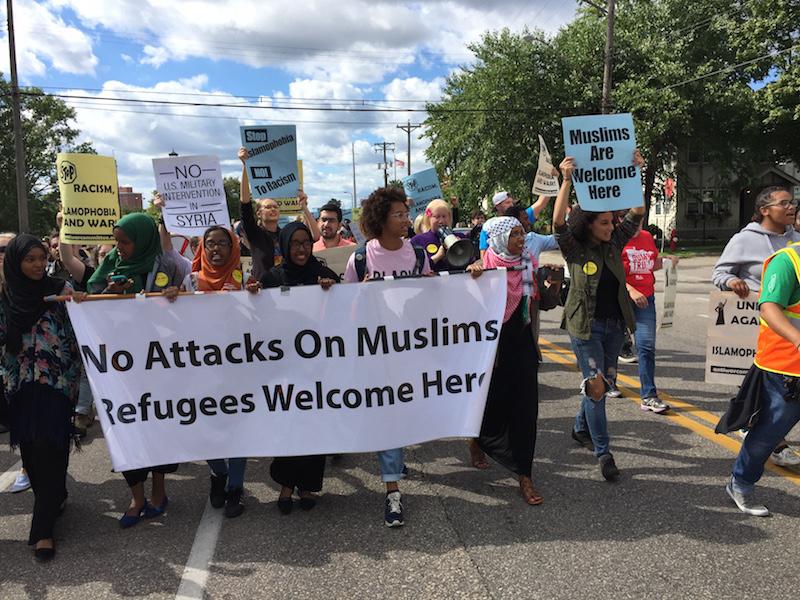 Photo Credit: Eli Shimanski A banner being supported by Ahalm Mussa. Aishah Mohammad and Ndolo Elate, three South students that participated in the march.