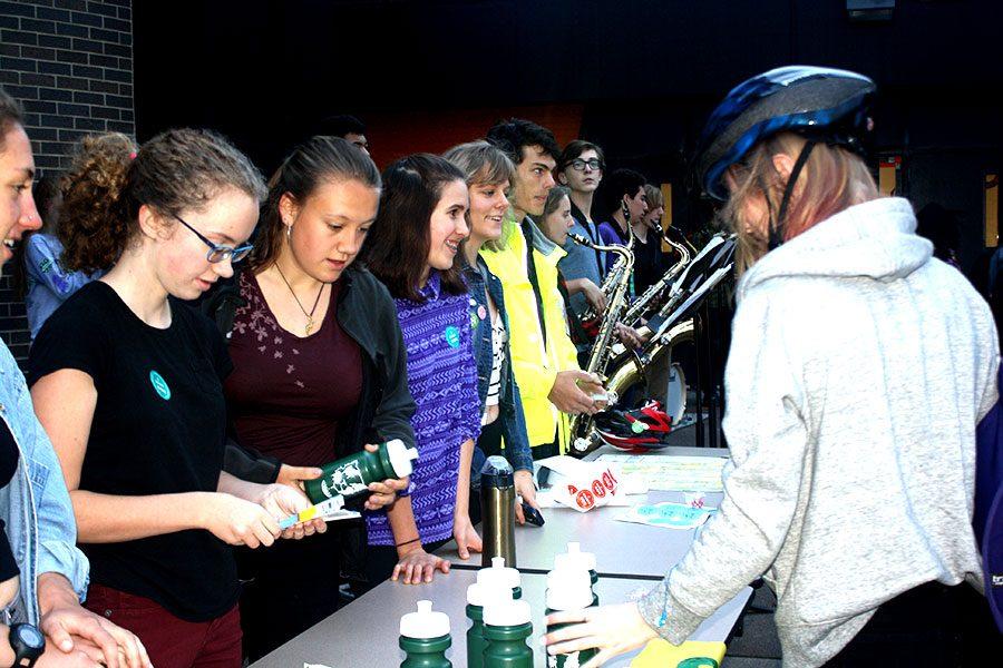 Photo: Samara Adam 
Green Tigers - South Highs environmental justice club - hands out waterbottles, bike lights and other donated prices to students who biked to school on Bike to School Day.  “It’s really good that people get out there and save the environment” said senior Celina Barnett-Cashman.
