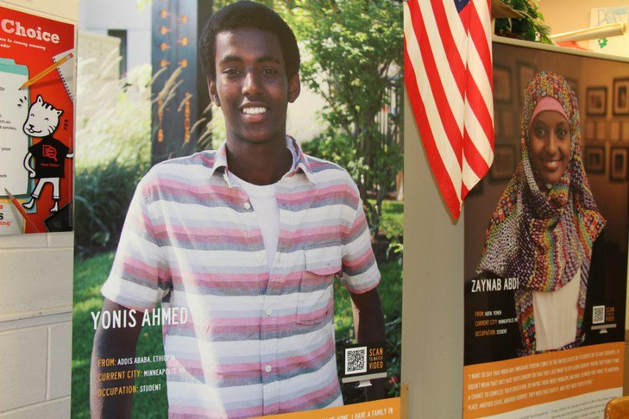 Yonis Ahmed, a student immigrant from Ethiopia in 2015, on one of Green Card Voices signs in the media center. Their goal is to help share the personal stories and experiences of immigrants with the hope of challenging stereotypes, and helping to build bridges of understanding and connection between immigrants and nonimmigrants. Photo: Sophia Manolis
