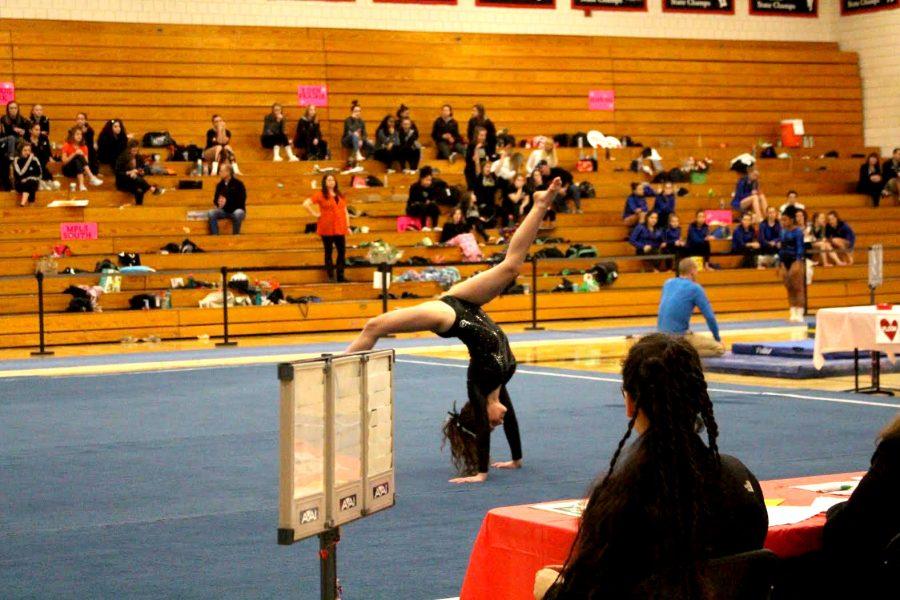 Seward eighth grader and gymnast for South, Ellie Barnett-Cashman, does a handstand during her floor routine at the Section 6AA Finals. At the final meet of the season South scored 116.925 points and came in 7th place. Gymnastics is a very physically demanding sport that requires full body effort. Several of South’s gymnasts feel that they receive less attention in comparison to other sports. 