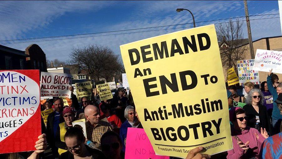 Protesters+march+for+immigrant+rights+in+response+to+the+first+travel+ban+instated+by+President+Trump.+Demand+an+end+to+anti-+muslim+bigotry%2C+the+sign+pictured+reads.