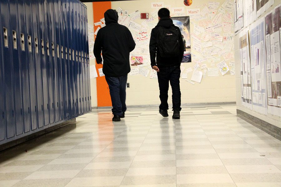 Two students wander the halls together instead of sitting in class. These students are just two of the many students that skip class.