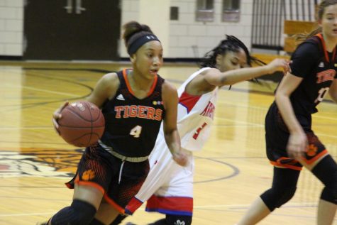 Freshmen Jade Hill makes her way around an Armstrong defender on her way to scaring a lay-up 