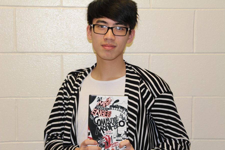 Ben Phi holding the communist manifesto which he considers an interesting and mind expanding read.  