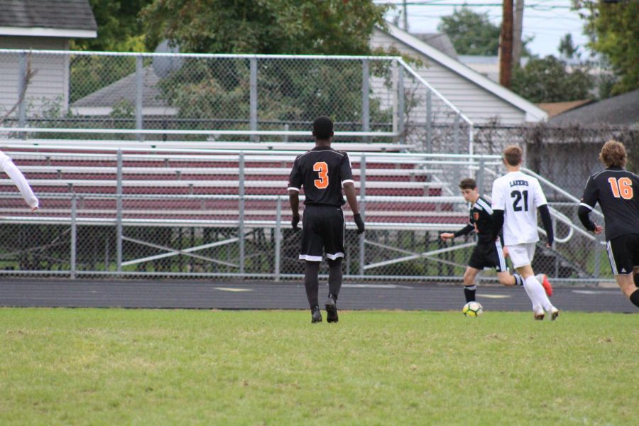 Captain Sam Kendrick in a game against Southwest on Super Soccer Saturday.  Head Coach Derric Johnson finds Kendrick’s cosmopolitan travels as a unique strength he has on the team. Johnson said “I think that [his traveling and experiences] do play into it.” Photo: Spencer Kimball