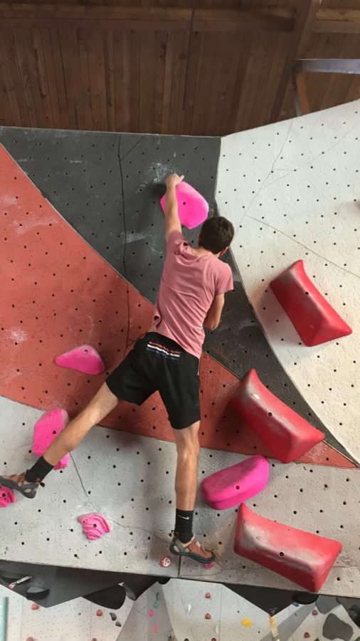 Henry Neufeld, an initial club member boulders at the Vertical Endeavors gym along with other club members. Members are very passionate about the sport, “I like rock climbing,” said Neufeld. 