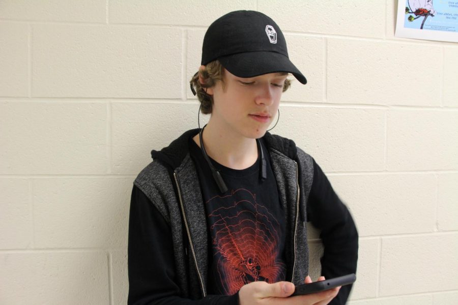 Aidan Sumner-Malmgren, a bassist and sophomore, listens to music on his headphones in the third floor of South high school. “I have no idea [what I’d do without a music app], I probably wouldnt listen to music,” said Sumner-Malmgren.