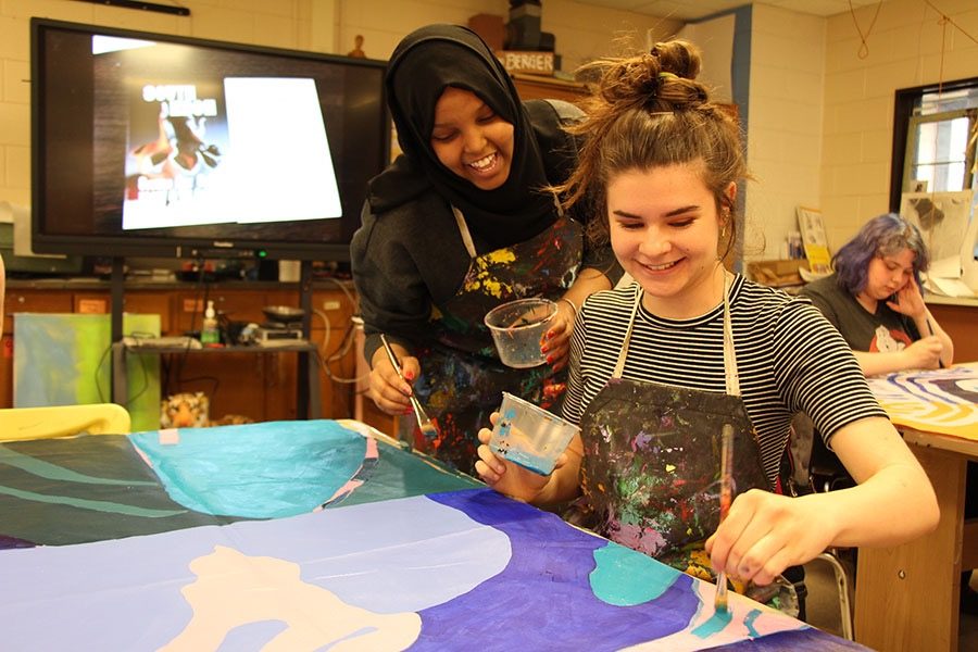 South High students Nasra Hassan and Frances Levy are just a few of the visual art students working together to paint the new mural for South. The mural that they are working on will be replacing the mural that is alongside the practice field by the end of June.