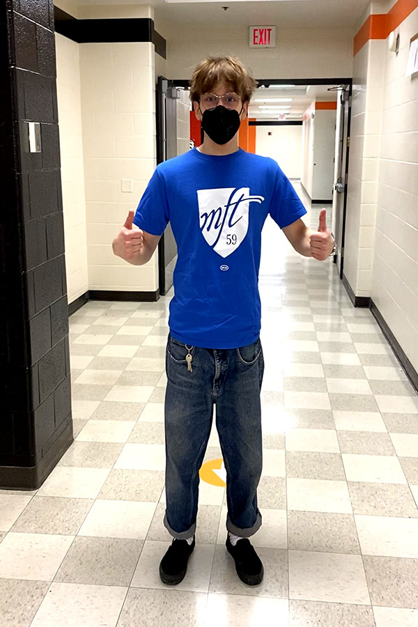 Senior Graham Doyle poses with a Minneapolis Federation of Teachers union shirt in support of the likely upcoming strike. 