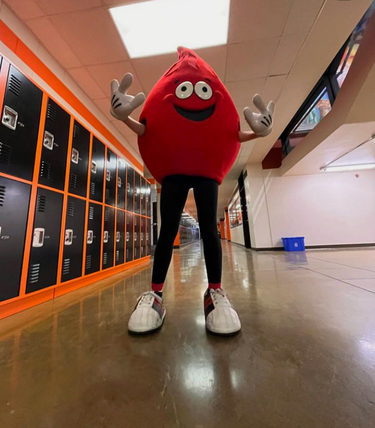 Senior Maria Muller wears the “ABO Joe” blood mascot to promote the blood drive. “Once you see the blood mascot,” said Student Council organizer Madeline Koebrick, “it’s incredible… people want to donate.” 