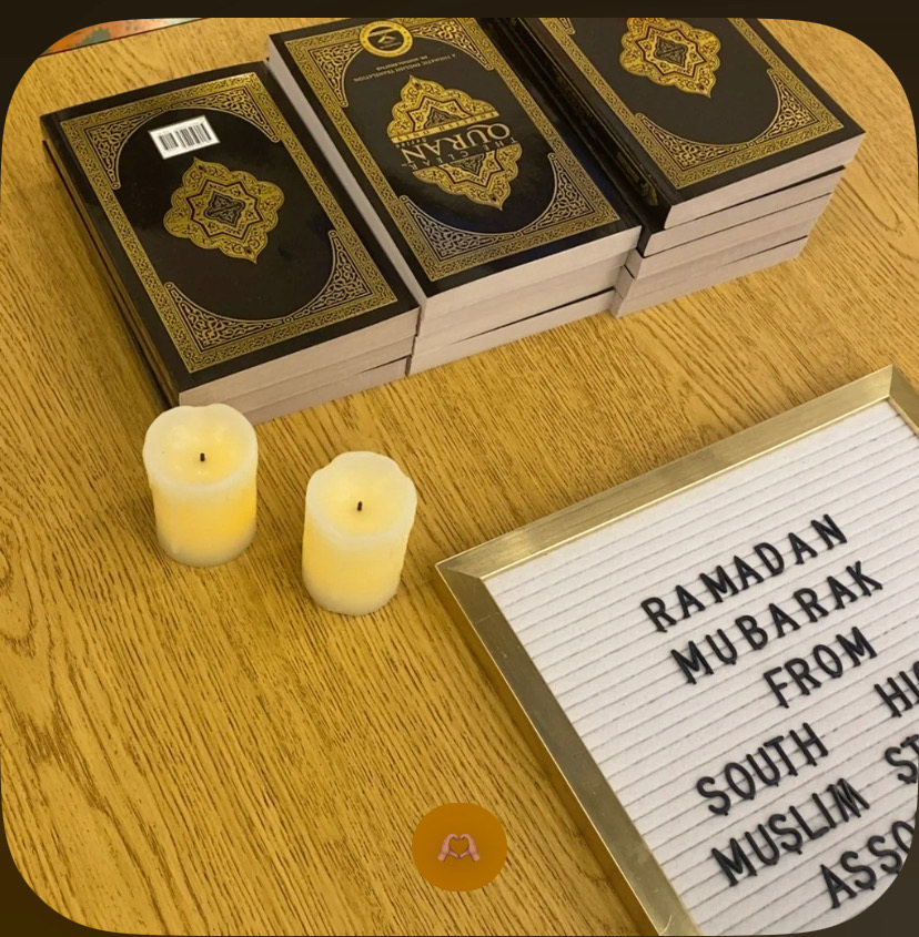 Taken on Iftar Night 2023, hosted by South High’s MSA, with stacked English translations of the Qur’an, alongside a sign greeting attendees ‘Ramadan Mubarak’.